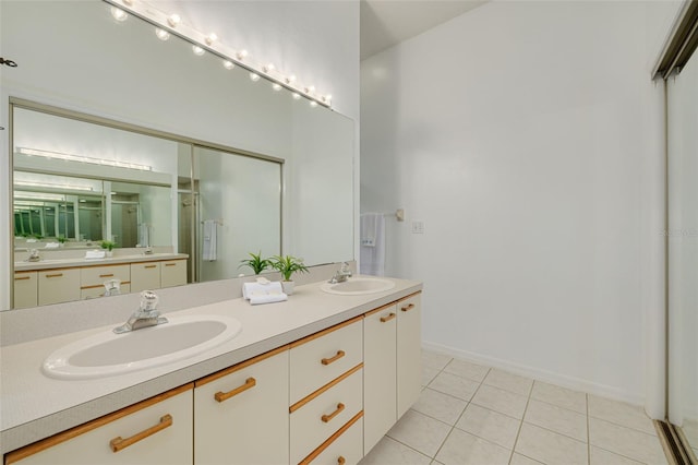 3044 Red Oak Ct Unit 204, Palm Harbor, FL 34684 - full bathroom featuring double vanity, tile patterned flooring, a shower stall, and baseboards