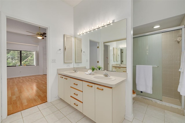 3044 Red Oak Ct Unit 204, Palm Harbor, FL 34684 - full bathroom with double vanity, tile patterned flooring, tiled shower, a ceiling fan, and toilet
