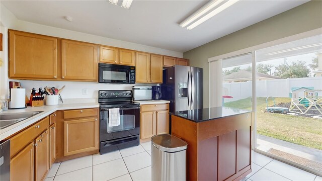 10739 Shady Preserve Dr, Riverview, FL 33579 - kitchen with black appliances, light tile patterned floors, a sink, and light countertops