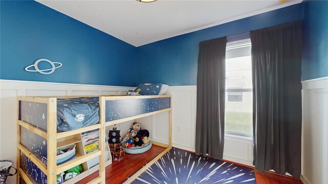 10739 Shady Preserve Dr, Riverview, FL 33579 - bedroom with a wainscoted wall, wood finished floors, and a decorative wall