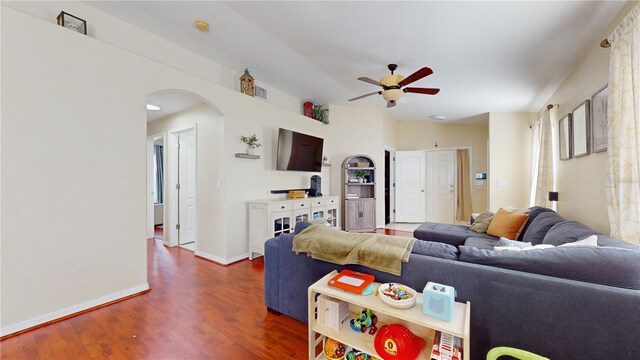 10739 Shady Preserve Dr, Riverview, FL 33579 - living room featuring a ceiling fan, arched walkways, dark wood finished floors, and baseboards