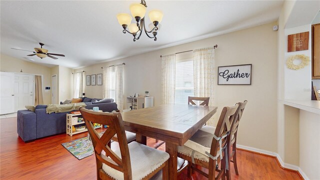 10739 Shady Preserve Dr, Riverview, FL 33579 - dining room featuring a chandelier, wood finished floors, ceiling fan, baseboards, and vaulted ceiling