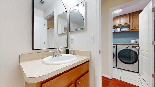 10739 Shady Preserve Dr, Riverview, FL 33579 - bathroom featuring washer and dryer, vanity, and wood finished floors
