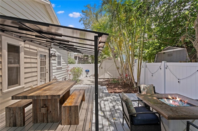 3620 W San Pedro St, Tampa, FL 33629 - wooden deck featuring a fenced backyard, a fire pit, and outdoor dining space