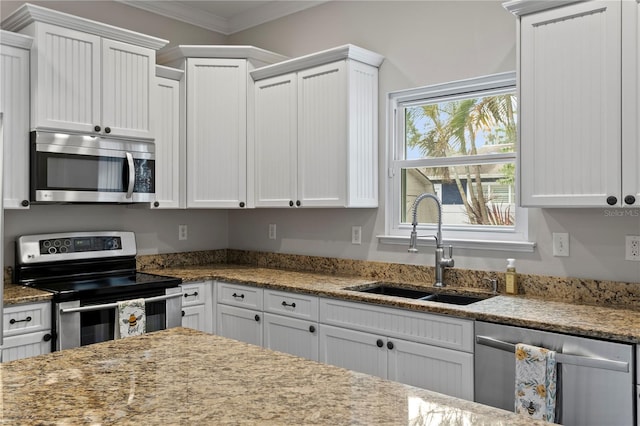 3620 W San Pedro St, Tampa, FL 33629 - kitchen with appliances with stainless steel finishes, a sink, ornamental molding, white cabinetry, and light stone countertops