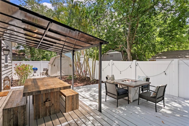 3620 W San Pedro St, Tampa, FL 33629 - wooden deck featuring outdoor dining space, a fenced backyard, and a fire pit