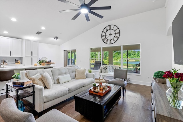 living room with high vaulted ceiling, recessed lighting, ceiling fan, dark wood-style floors, and baseboards