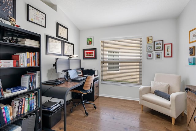 home office featuring wood finished floors and baseboards