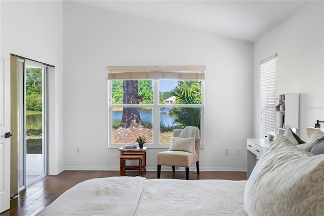 bedroom with access to exterior, vaulted ceiling, wood finished floors, and baseboards