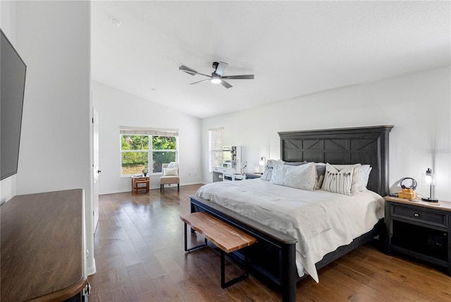 bedroom with wood finished floors, vaulted ceiling, ceiling fan, and baseboards