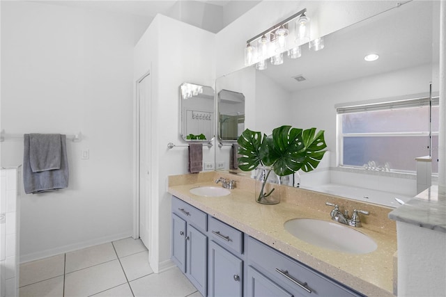 full bathroom featuring tile patterned flooring, double vanity, baseboards, and a bath