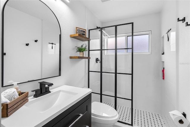 bathroom with a stall shower, toilet, and vanity