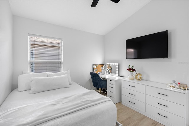 bedroom with lofted ceiling, light wood-style flooring, and a ceiling fan