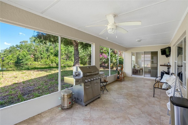 sunroom / solarium with a ceiling fan and healthy amount of natural light