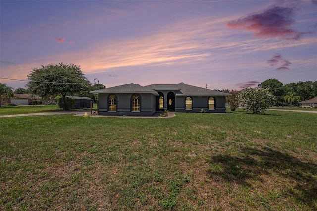 31645 Bugle Ln, Wesley Chapel, FL 33543 - view of front of property with a front lawn, stucco siding, and a porch