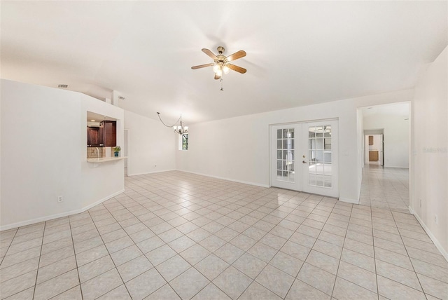 31645 Bugle Ln, Wesley Chapel, FL 33543 - empty room with ceiling fan, french doors, a chandelier, and light tile patterned flooring