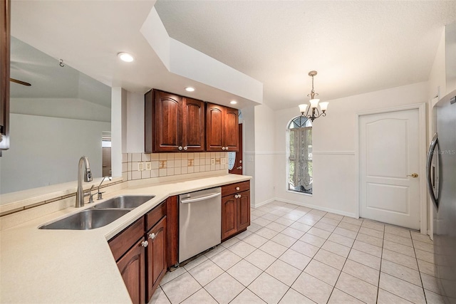 31645 Bugle Ln, Wesley Chapel, FL 33543 - kitchen with stainless steel appliances, a chandelier, light countertops, decorative backsplash, and hanging light fixtures