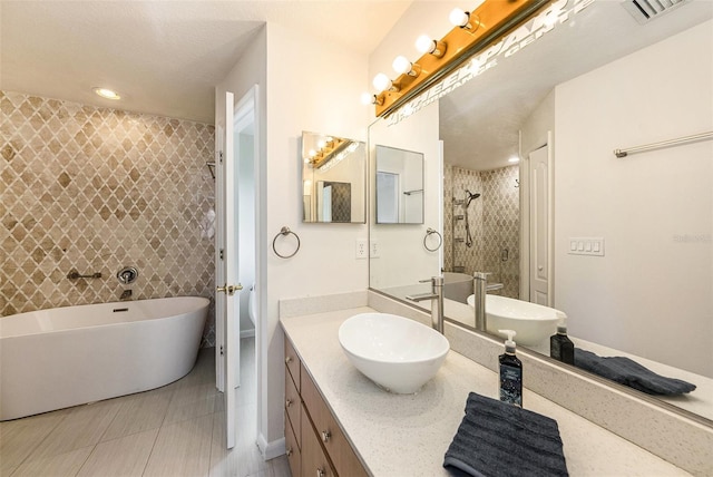 31645 Bugle Ln, Wesley Chapel, FL 33543 - full bath featuring a freestanding bath, tile patterned floors, vanity, and tiled shower