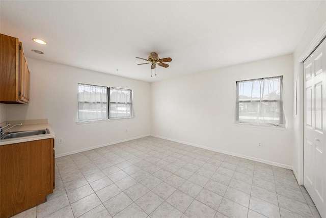 31645 Bugle Ln, Wesley Chapel, FL 33543 - kitchen with brown cabinets, healthy amount of natural light, ceiling fan, and recessed lighting