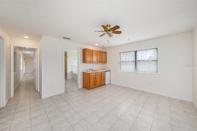 31645 Bugle Ln, Wesley Chapel, FL 33543 - kitchen featuring dishwashing machine, light countertops, ceiling fan, recessed lighting, and light tile patterned floors