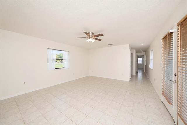 31645 Bugle Ln, Wesley Chapel, FL 33543 - empty room with ceiling fan, healthy amount of natural light, a textured ceiling, and recessed lighting
