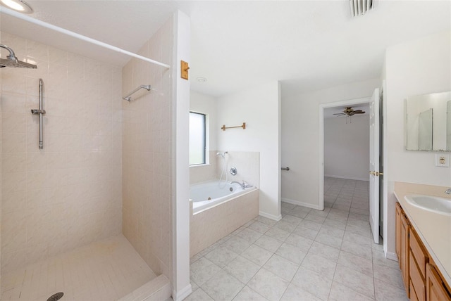 31645 Bugle Ln, Wesley Chapel, FL 33543 - bathroom with a garden tub, vanity, tiled shower, and tile patterned floors