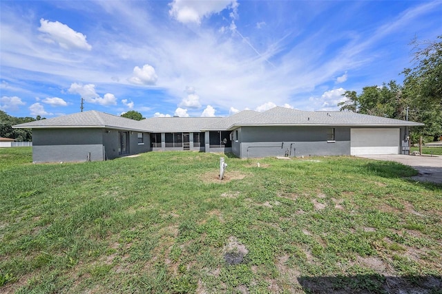 31645 Bugle Ln, Wesley Chapel, FL 33543 - back of property featuring an attached garage, a lawn, and concrete driveway