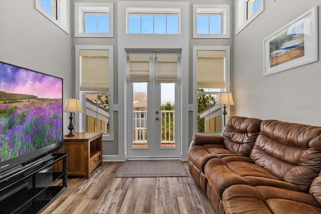 340 Sapphire Lake Dr Unit 202, Bradenton, FL 34209 - living area with french doors, wood finished floors, a high ceiling, and healthy amount of natural light