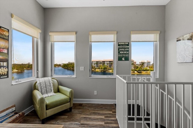 340 Sapphire Lake Dr Unit 202, Bradenton, FL 34209 - living area with wood finished floors, a water view, baseboards, and an upstairs landing
