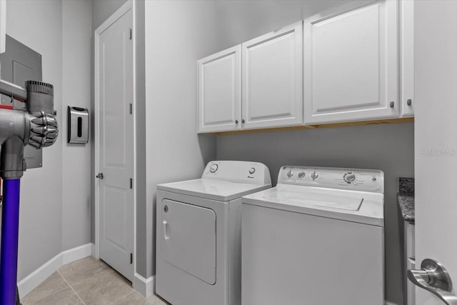 340 Sapphire Lake Dr Unit 202, Bradenton, FL 34209 - laundry area with cabinet space, washing machine and dryer, baseboards, and light tile patterned floors