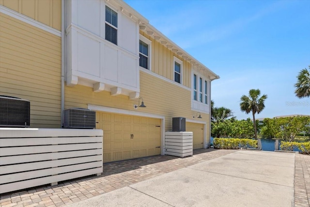 340 Sapphire Lake Dr Unit 202, Bradenton, FL 34209 - back of property with board and batten siding, decorative driveway, and a garage
