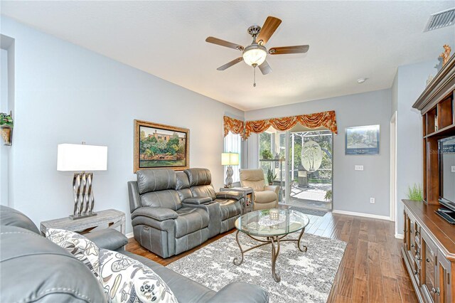 6030 Sandhill Ridge Dr, Lithia, FL 33547 - living room featuring baseboards, dark wood finished floors, and a ceiling fan