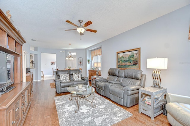 6030 Sandhill Ridge Dr, Lithia, FL 33547 - living room with ceiling fan, light wood-type flooring, and a textured ceiling