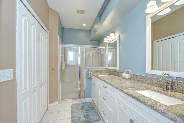 6030 Sandhill Ridge Dr, Lithia, FL 33547 - bathroom with a stall shower, double vanity, tile patterned flooring, and a closet