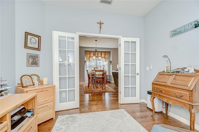 6030 Sandhill Ridge Dr, Lithia, FL 33547 - office space with french doors, light wood finished floors, a chandelier, and baseboards