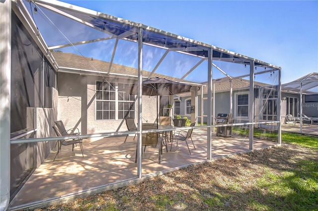6030 Sandhill Ridge Dr, Lithia, FL 33547 - back of house featuring stucco siding, a lanai, and a patio