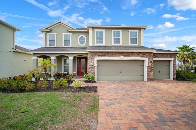 11550 Lake Lucaya Dr, Riverview, FL 33579 - view of front facade with a porch, stucco siding, decorative driveway, and an attached garage