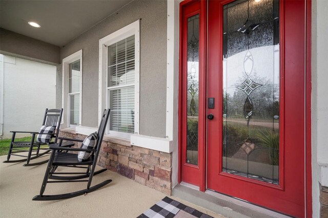 11550 Lake Lucaya Dr, Riverview, FL 33579 - view of exterior entry with a porch and stucco siding