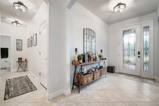 11550 Lake Lucaya Dr, Riverview, FL 33579 - foyer with healthy amount of natural light, light tile patterned flooring, and baseboards