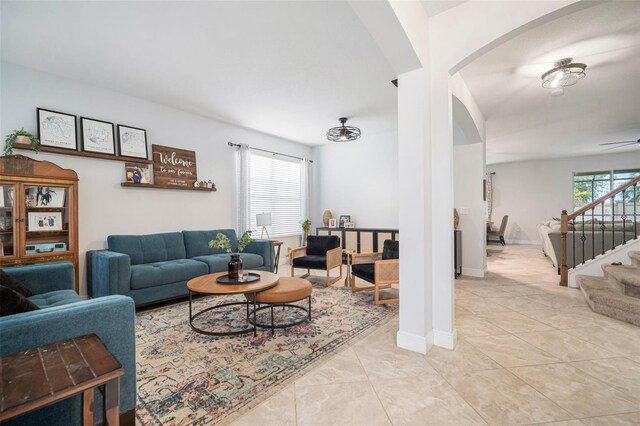 11550 Lake Lucaya Dr, Riverview, FL 33579 - living area featuring arched walkways, ceiling fan, and stairway