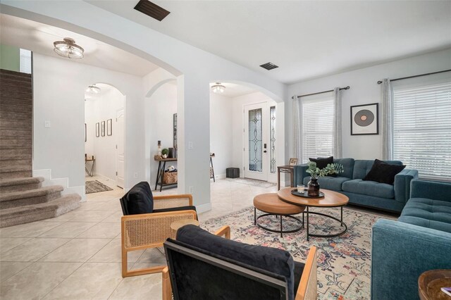 11550 Lake Lucaya Dr, Riverview, FL 33579 - living area with light tile patterned floors, arched walkways, stairs, and baseboards