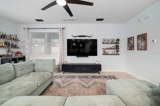 11550 Lake Lucaya Dr, Riverview, FL 33579 - living room featuring ceiling fan, a bar, baseboards, and tile patterned floors