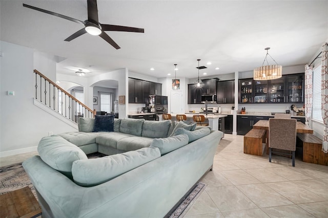 11550 Lake Lucaya Dr, Riverview, FL 33579 - living room featuring a ceiling fan, a chandelier, arched walkways, light tile patterned floors, and recessed lighting