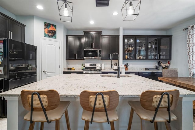 11550 Lake Lucaya Dr, Riverview, FL 33579 - kitchen with a sink, stainless steel appliances, an island with sink, hanging light fixtures, and recessed lighting