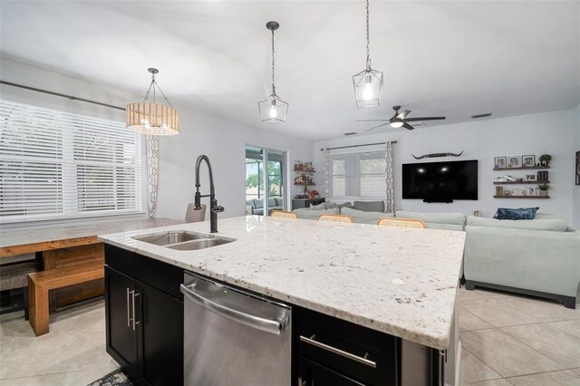 11550 Lake Lucaya Dr, Riverview, FL 33579 - kitchen with dishwasher, dark cabinetry, light tile patterned floors, and a sink
