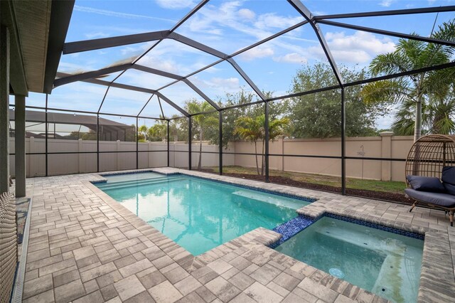 11550 Lake Lucaya Dr, Riverview, FL 33579 - view of swimming pool with a patio, a fenced backyard, a pool with connected hot tub, and glass enclosure