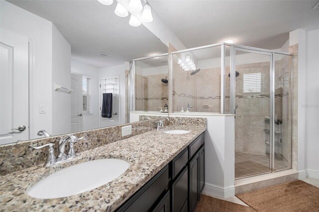 11550 Lake Lucaya Dr, Riverview, FL 33579 - full bathroom featuring a stall shower, double vanity, and baseboards