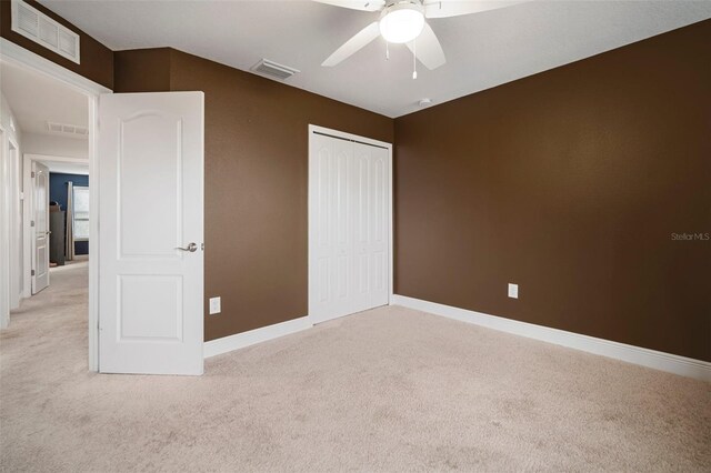 11550 Lake Lucaya Dr, Riverview, FL 33579 - unfurnished bedroom with light carpet, a closet, baseboards, and a ceiling fan
