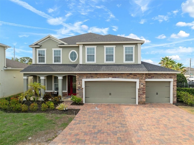 11550 Lake Lucaya Dr, Riverview, FL 33579 - view of front of house featuring covered porch, decorative driveway, stucco siding, an attached garage, and a shingled roof