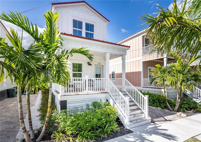 340 6th St E, Bradenton, FL 34208 - view of front of house featuring covered porch, stairs, and board and batten siding